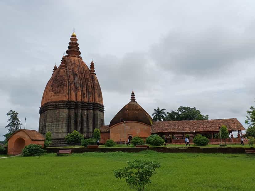 The towering Sivadol temple shikhara rising above its terrace beside the Sivasagar tank, with adjoining domed shrine and prayer hall