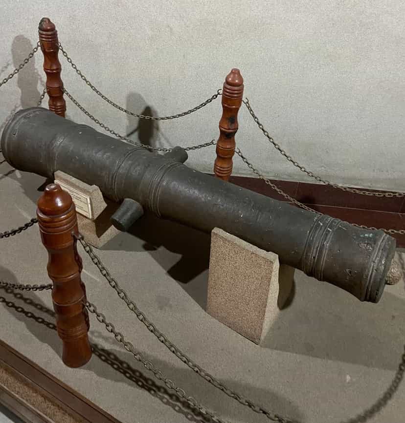A bronze Mughal cannon captured by the Ahoms after the Battle of Itakhuli, displayed on a museum stand