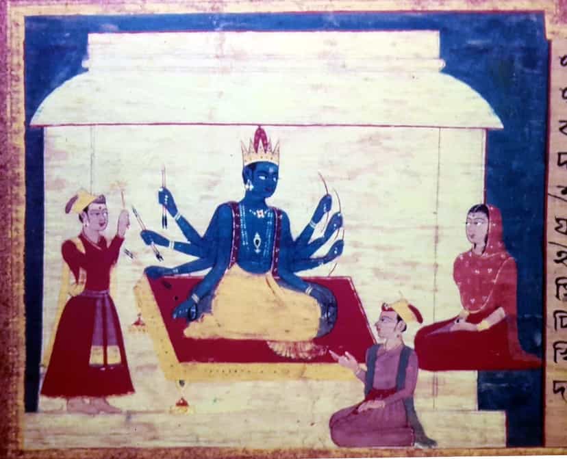 An Assamese manuscript painting: a blue, many-armed crowned deity seated on a red dais under a pavilion, an attendant offering at left and a seated woman at right, a column of old Assamese script running down the right edge