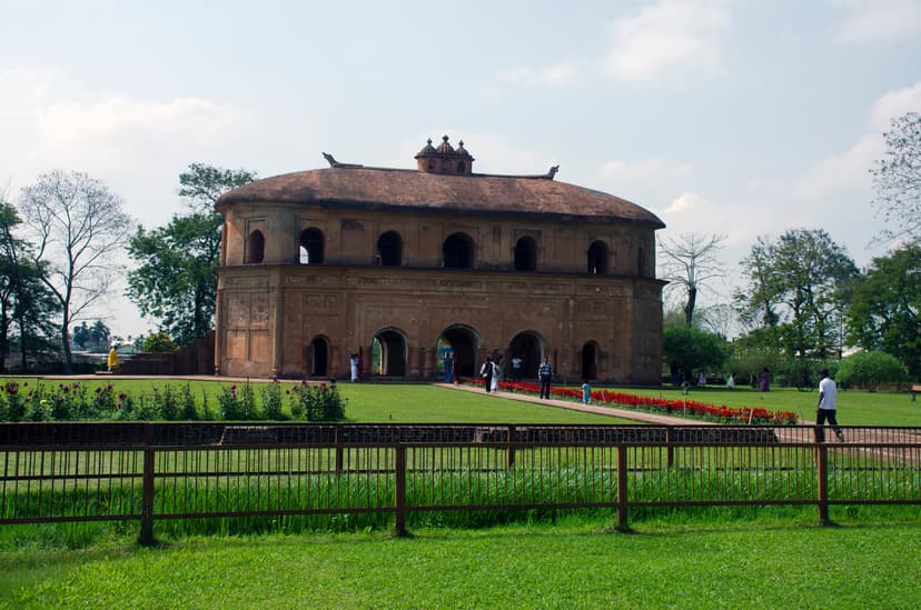 The oval two-storeyed Rang Ghar royal pavilion near Sivasagar, with arched ground floor and carved roof finials