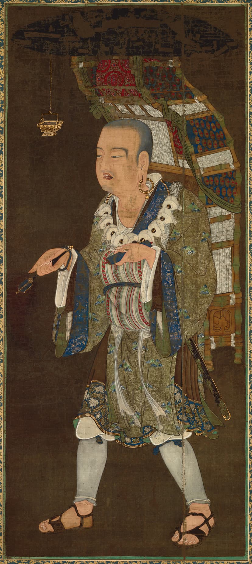 Traditional East Asian painting of the monk Xuanzang walking with a wicker pack of scriptures on his back