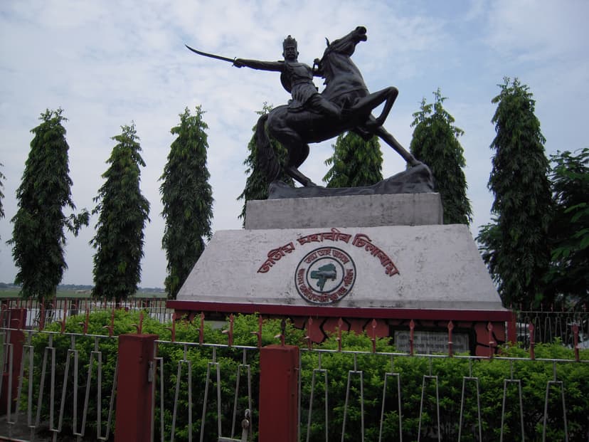 Bronze equestrian statue of the Koch general Chilarai, mounted on a rearing horse with sword raised, on an inscribed pedestal in Dhubri