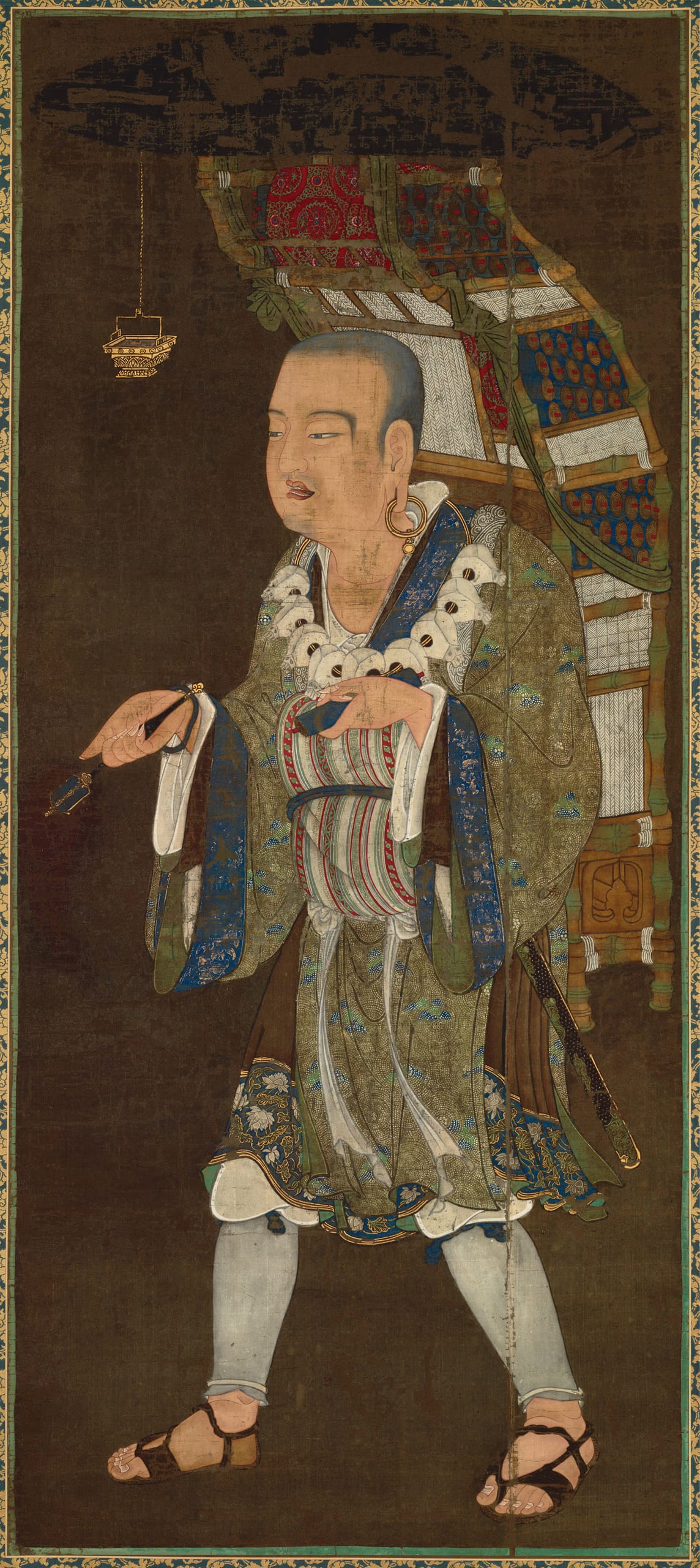 Traditional East Asian painting of the monk Xuanzang walking with a wicker pack of scriptures on his back