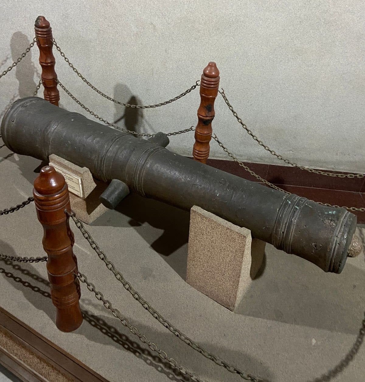 A bronze Mughal cannon captured by the Ahoms after the Battle of Itakhuli, displayed on a museum stand