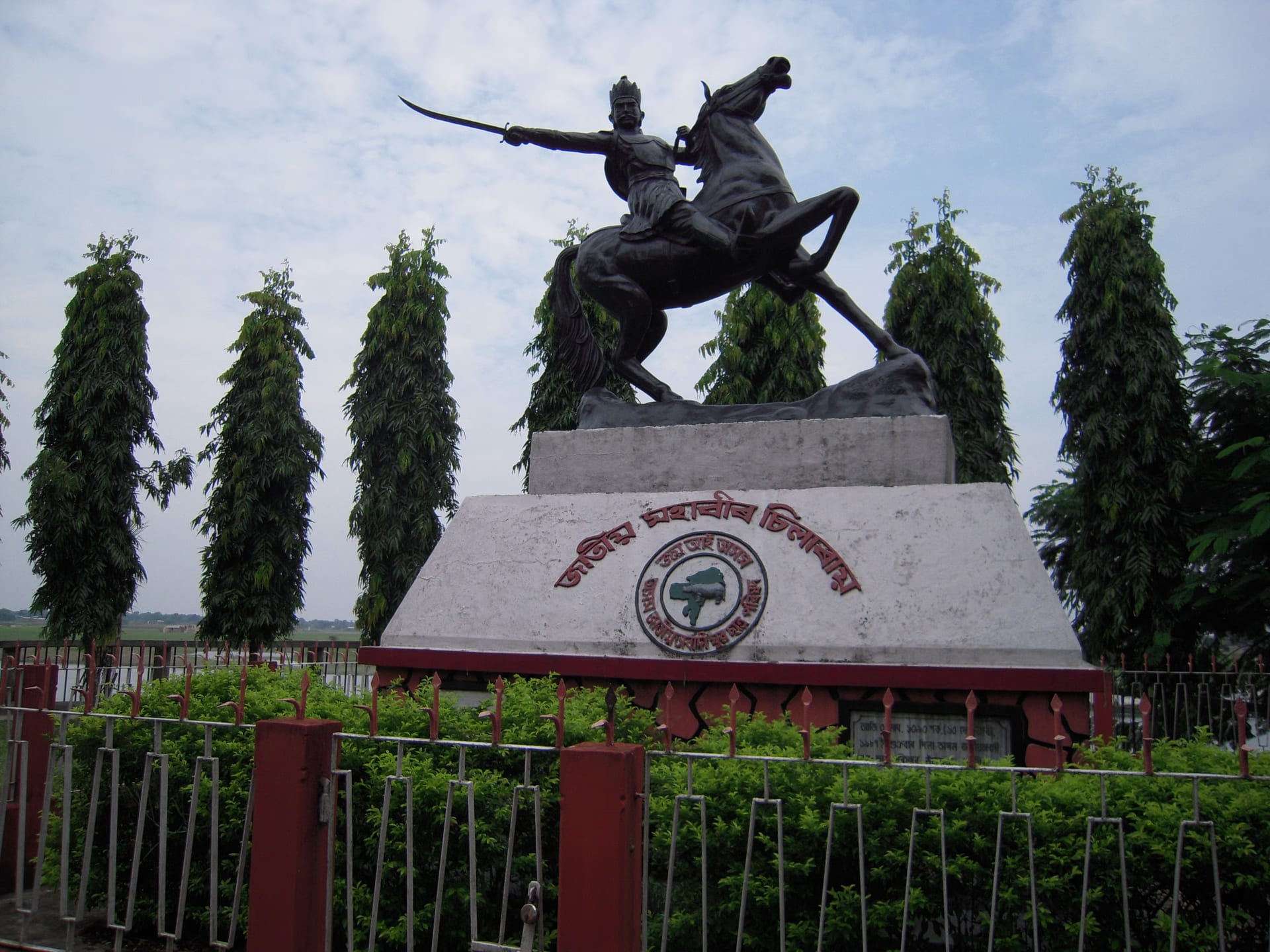 Bronze equestrian statue of the Koch general Chilarai, mounted on a rearing horse with sword raised, on an inscribed pedestal in Dhubri