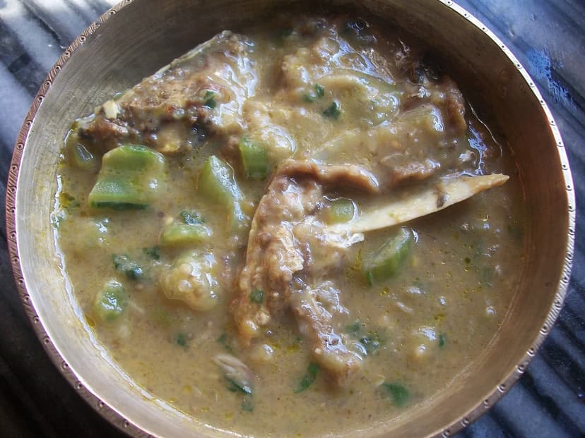 A bowl of fish-head khar, an alkaline curry with raw papaya, seen from above