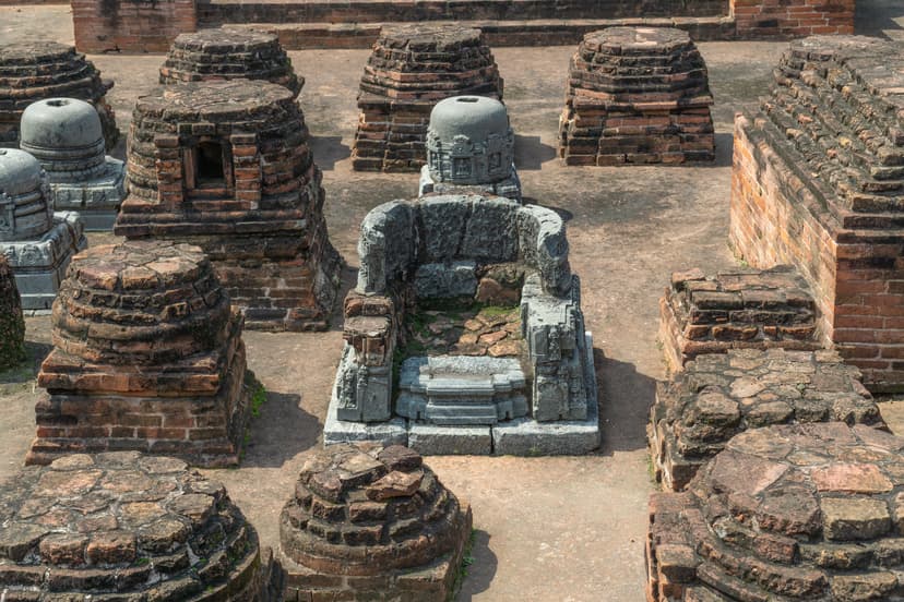 Rows of brick votive stupas and monastic ruins in sunlight at Nalanda Mahavihara