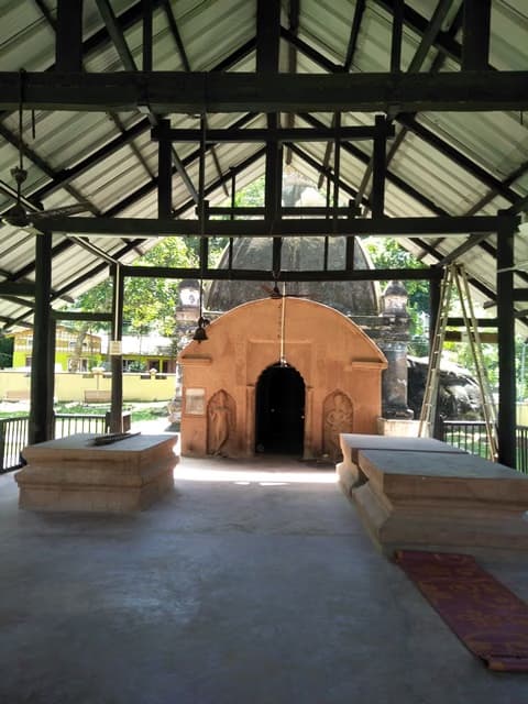 Small stone Ganesh shrine under a protective metal roof at Hajo, Assam