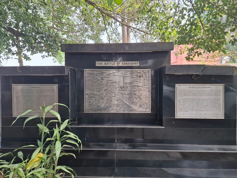 Black stone memorial at Sukreswar with a silver-toned metal relief of the naval battle of Saraighat between Assamese and English plaques